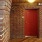 red door surrounded by red brick walls in hallway